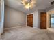 Neutral bedroom with carpet, fan and ceiling light fixture and a double-door closet for convenient storage at 1633 Belfield St, Indianapolis, IN 46217
