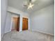 Bright bedroom with neutral walls, carpet, and a double-door closet for ample storage space at 1633 Belfield St, Indianapolis, IN 46217