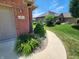 View of house number and landscaping, featuring a stone mulch bed and flowering bushes at 1633 Belfield St, Indianapolis, IN 46217
