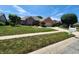 Beautiful brick home featuring a lush green lawn and professional landscaping at 1633 Belfield St, Indianapolis, IN 46217