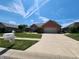 Charming brick home with a well-manicured lawn and a two-car garage at 1633 Belfield St, Indianapolis, IN 46217