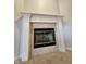 Close-up of the fireplace with white mantel and stone tile surround at 1633 Belfield St, Indianapolis, IN 46217