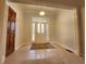 Inviting foyer with tile flooring, white front door with sidelights and a decorative rug at 1633 Belfield St, Indianapolis, IN 46217