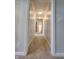 Bright hallway is carpeted and leads to the bedrooms and bathrooms at 1633 Belfield St, Indianapolis, IN 46217