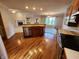 Spacious kitchen adjacent to living area; features stainless appliances and wood floors at 1633 Belfield St, Indianapolis, IN 46217