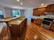 Bright kitchen with breakfast bar, stainless steel appliances, and hardwood flooring at 1633 Belfield St, Indianapolis, IN 46217