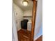 Convenient laundry room includes a side-by-side washer and dryer, storage shelf, and access to the exterior at 1633 Belfield St, Indianapolis, IN 46217