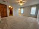 Spacious carpeted main bedroom featuring a ceiling fan, natural light and an attached walk-in closet at 1633 Belfield St, Indianapolis, IN 46217
