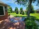 Cozy patio area with outdoor furniture, surrounded by lush greenery and a meticulously landscaped yard at 1633 Belfield St, Indianapolis, IN 46217
