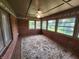Bright sunroom with brick walls, tile flooring, and large windows offering ample natural light at 1633 Belfield St, Indianapolis, IN 46217