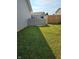 A spacious backyard featuring a well-maintained lawn and multiple fences at 1706 Creekwater Pass, Greenfield, IN 46140
