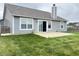 Well-maintained home exterior featuring a sliding glass door and windows overlooking the grassy backyard at 1706 Creekwater Pass, Greenfield, IN 46140