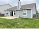 A well maintained backyard with concrete patio, grassy area, and siding on a cloudy day at 1706 Creekwater Pass, Greenfield, IN 46140