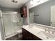 Bathroom boasts a double sink vanity, framed mirror, and enclosed shower at 1706 Creekwater Pass, Greenfield, IN 46140