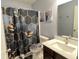 Bathroom features a patterned shower curtain and matching toilet seat for a stylish look at 1706 Creekwater Pass, Greenfield, IN 46140