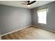 Empty bedroom with plush carpet, neutral walls, a ceiling fan, and a bright window at 1706 Creekwater Pass, Greenfield, IN 46140