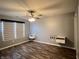 Neutral bedroom with modern floating shelves and light wood-look flooring, with a bright window at 1706 Creekwater Pass, Greenfield, IN 46140