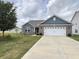 Well-maintained single-story home featuring a manicured lawn, two-car garage and vibrant flowerbeds at 1706 Creekwater Pass, Greenfield, IN 46140