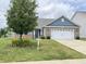 Charming single-story home featuring a two-car garage, well-manicured lawn and beautiful landscaping at 1706 Creekwater Pass, Greenfield, IN 46140