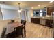 A kitchen and dining area featuring stainless steel appliances, stylish light fixtures and wood floors at 1706 Creekwater Pass, Greenfield, IN 46140