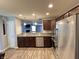 Bright kitchen featuring stainless steel appliances, wood floors, and a view into the living area at 1706 Creekwater Pass, Greenfield, IN 46140