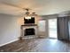 Bright living room with gray walls and a stone fireplace, open to a sliding glass door at 1706 Creekwater Pass, Greenfield, IN 46140