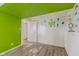 Finished room with laminate flooring, quirky ceiling, and bright decor accents at 1809 Mutz Dr, Indianapolis, IN 46229