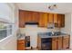 Kitchen featuring wooden cabinets, laminate countertop, and a window at 1809 Mutz Dr, Indianapolis, IN 46229
