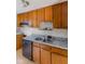Kitchen featuring wooden cabinets and a black dishwasher at 1809 Mutz Dr, Indianapolis, IN 46229