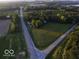 Aerial shot of roads leading to the property surrounded by green spaces and scattered trees at 18378 Southeastern Pkwy, Fortville, IN 46040
