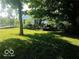 View of the backyard featuring a deck and surrounded by trees, providing a relaxing outdoor space at 18378 Southeastern Pkwy, Fortville, IN 46040