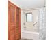 Bathroom featuring a shower and tub with a decorative shower curtain and built-in storage in the tub at 18378 Southeastern Pkwy, Fortville, IN 46040
