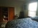 Cozy bedroom featuring a wood wardrobe and a relaxing window view at 18378 Southeastern Pkwy, Fortville, IN 46040