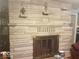The fireplace has a gray stone finish and sits below two decorative lamps at 18378 Southeastern Pkwy, Fortville, IN 46040