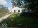 Charming front exterior with wooden ramp and lush landscaping, perfect for relaxing outdoors at 18378 Southeastern Pkwy, Fortville, IN 46040