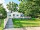 Charming exterior of a home featuring a wooden ramp, chimney and front porch, surrounded by lush greenery at 18378 Southeastern Pkwy, Fortville, IN 46040