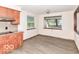 Eat-in kitchen featuring wood cabinets, granite countertops, and windows at 18378 Southeastern Pkwy, Fortville, IN 46040