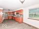 Kitchen with wooden cabinets, a window above the sink, and space for a dining area at 18378 Southeastern Pkwy, Fortville, IN 46040
