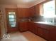 Functional kitchen with wooden cabinets and a window-lit sink area at 18378 Southeastern Pkwy, Fortville, IN 46040