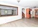 Open-concept living room featuring a brick fireplace and hardwood floors at 18378 Southeastern Pkwy, Fortville, IN 46040