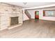 Inviting living room featuring a fireplace, staircase, and updated flooring for comfort and style at 18378 Southeastern Pkwy, Fortville, IN 46040