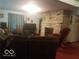 Inviting living room with a stone fireplace as a focal point at 18378 Southeastern Pkwy, Fortville, IN 46040