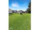Grassy backyard featuring chairs around a fire pit, offering ample space for relaxation and recreation at 205 Eikenberry St, Greenfield, IN 46140