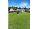 Grassy backyard featuring chairs around a fire pit, with a mix of sun and shade at 205 Eikenberry St, Greenfield, IN 46140