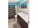 Renovated bathroom features dark wood cabinetry, modern fixtures, and a shower with a black and white curtain at 205 Eikenberry St, Greenfield, IN 46140