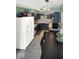 An airy kitchen with white appliances, green wall paint, and dark cabinetry provides a functional layout at 205 Eikenberry St, Greenfield, IN 46140