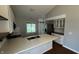 Well-lit kitchen featuring white cabinets, stainless steel appliances, and a central island with a built-in sink at 2083 Kerns Ct, Carmel, IN 46280
