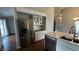 Kitchen view showcasing modern stainless steel appliances, white cabinetry, and a center island with a sink at 2083 Kerns Ct, Carmel, IN 46280