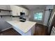 Bright kitchen with white cabinets, stainless steel appliances, and a center island with a breakfast bar at 2083 Kerns Ct, Carmel, IN 46280