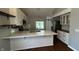 Modern kitchen with stainless steel appliances, a large center island, and a sink with views of the backyard at 2083 Kerns Ct, Carmel, IN 46280